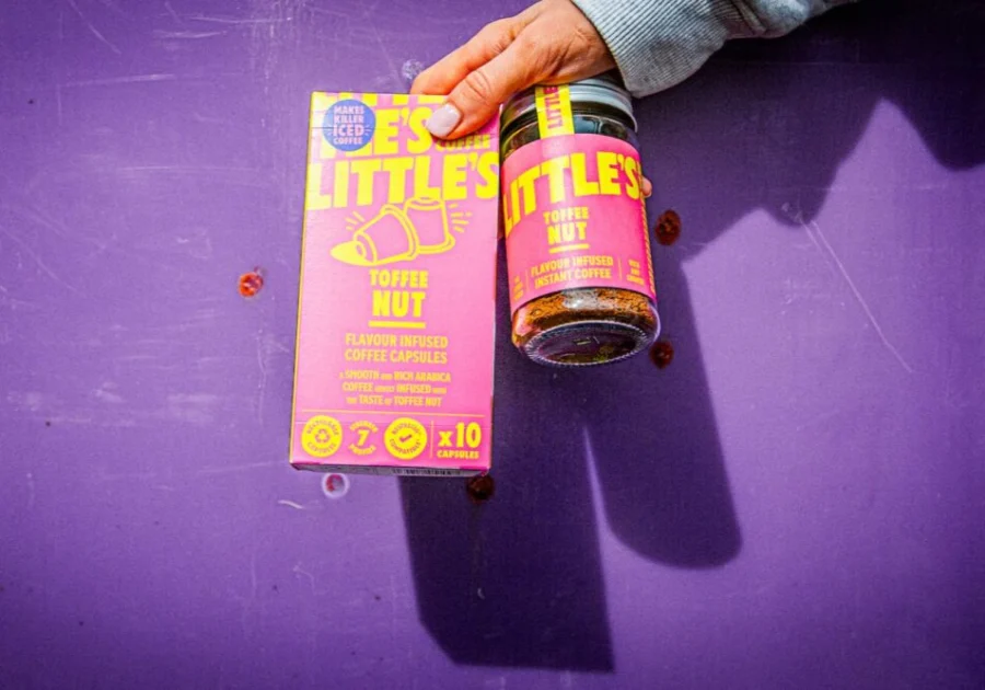 Little's Toffee Nut capsules and instant coffee products held up against purple background.