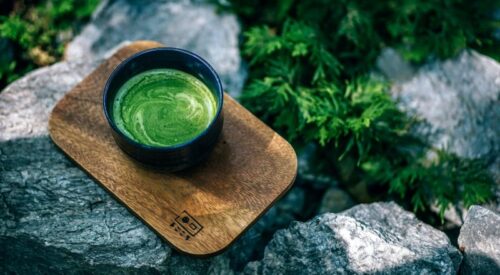 Cup of matcha on a wooden board